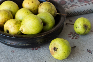  Pears.  Ripe pears in a wooden bowl on tablecloths from flax.