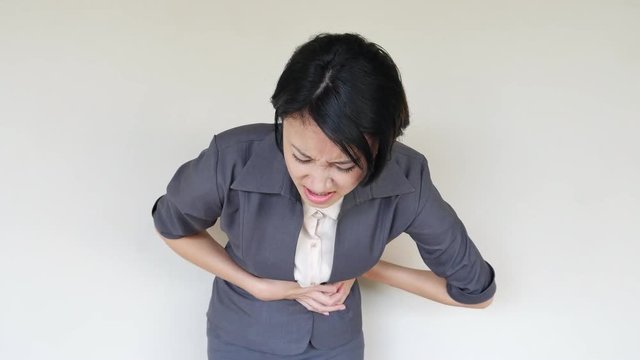 businesswoman suffering from stomachache, menstrual cramp, indigestion, flatulence