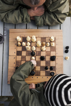 Boy with grandfather playing chess, high angle view