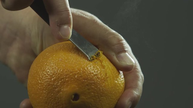 Slow motion peeling orange skin