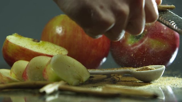 Grating cinnamon stick with apples