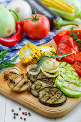 Set of grilled vegetables meal and ingredients: tomato, corn, eggplant, mushroom, bell pepper, marrow and onion. Healthy organic food on a table.