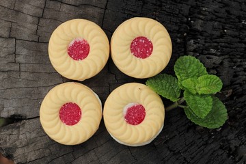 Strawberry biscuits is delicious on wood background.