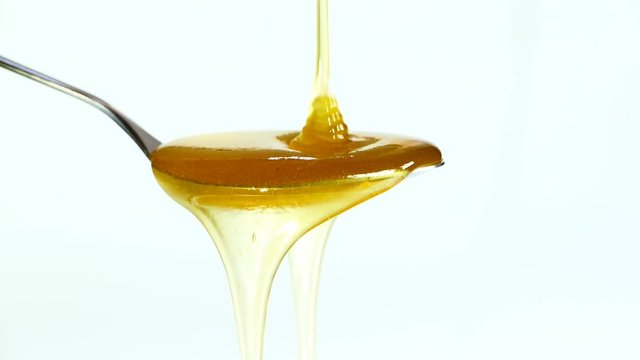 honey dripping on a spoon close-up
