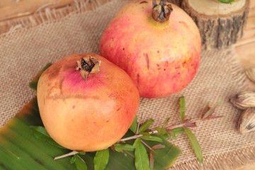Fototapeta na wymiar Ripe pomegranate fruit delicious on wood background.