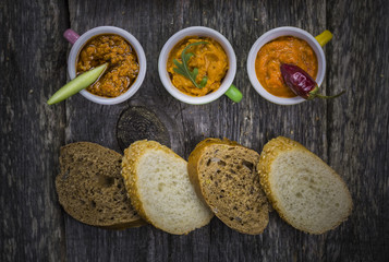 three various pesto on vintage table