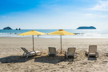 Parasol with chairs at Playa Espadilla at Manuel Antonio Park - Costa Rica