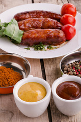 Sausage. Delicious sausages in a plate with ingredients. Salad.