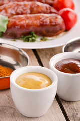 Sausage. Delicious sausages in a plate with ingredients. Salad.