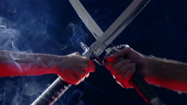 Japanese samurai warriors fighting with swords. Sword battle. Two Japanese katana sword. Blade close-up on a dark background with blue light filter with incense smoke. Steel tempering