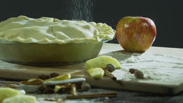 Sprinkling sugar onto apple pie