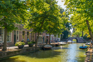 Fototapeta na wymiar Baangracht canal with trees and boats in Alkmaar, North Holland, Netherlands