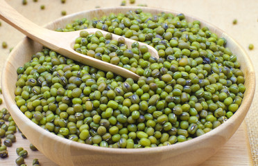 Green bean or mung bean in bowl and sack background.