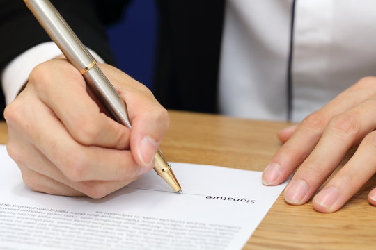 businessman hand signing a contract paper
