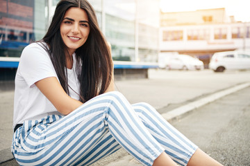 Fototapeta premium Beautiful woman wearing striped pants smiles