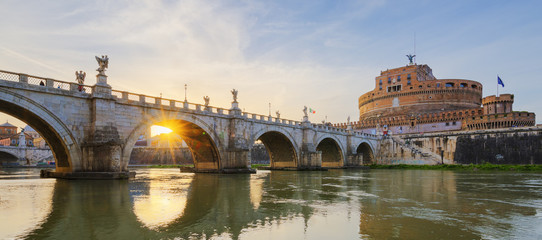 Holy Angel Bridge over the Tiber River in Rome at sunset.