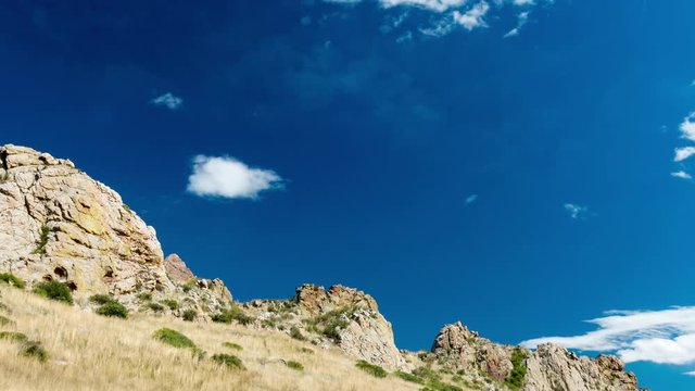 A time lapse of stratus and cumulus clouds emerging and changing as they move past a section of the Devils Backbone near Loveland Colorado. 4K