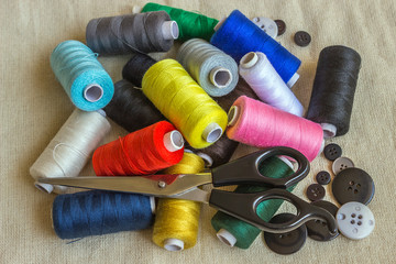 Sewing accessories. Spools of different color thread, scissors
