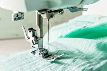 sewing machine working part with green cloth