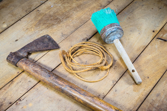 Rusty hammer, rope and used brush