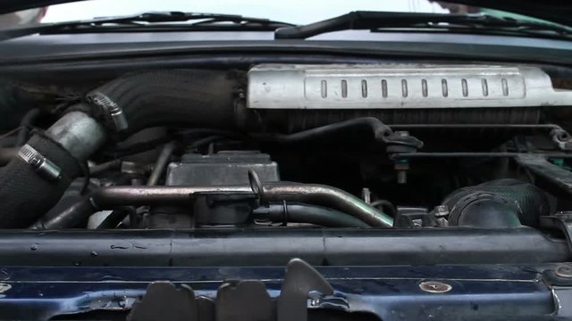 Mechanic Adding Coolant to Car radiators
