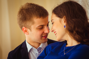 Blue crystals sparkle in woman's ears while she kisses with her