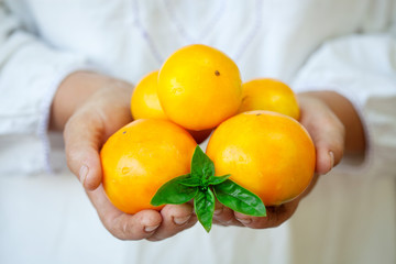 Handful of yellow fresh tomatoes.