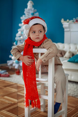 Boy in Christmas hat. The concept of the New Year and Merry Christmas