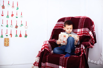 boy reading a book. The concept of the New Year and Merry Christmas