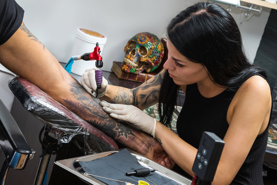 Tattoo artist during her work