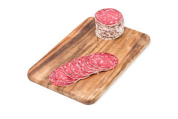 Slices of salami on wooden board