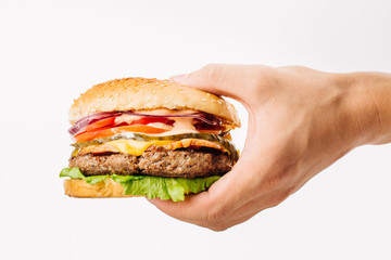 man holding a burger on white background