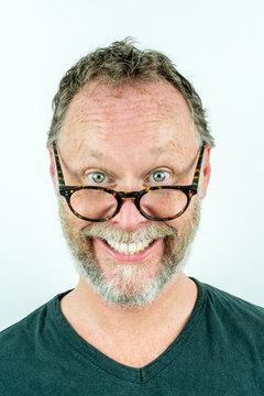Happy man with beard and glasses laughing, funny portrait. Casual clothing.