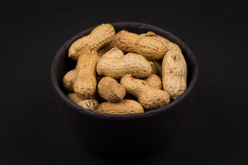 Raw peanuts shells in bowl