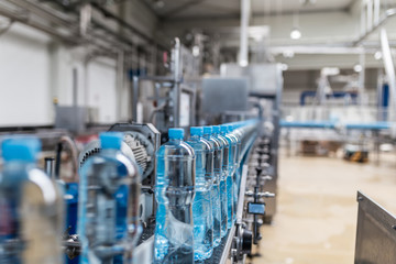 Water factory - Water bottling line for processing and bottling pure mineral carbonated water into bottles. Selective focus. 