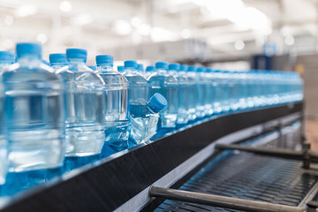 Water factory - Water bottling line for processing and bottling pure mineral carbonated water into bottles. Selective focus. 