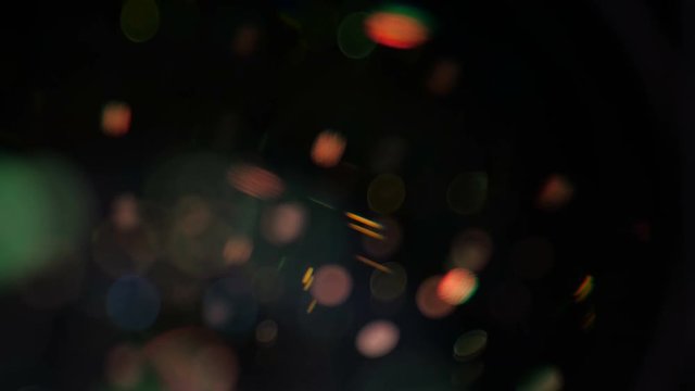 Camera lens flare closeup with laminated reflection on a big front element of superzoom lens.
