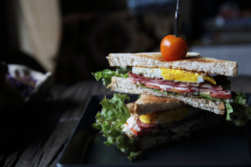 club sandwiches on wood background with mystic light