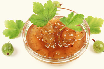 gooseberry jam on a white wooden background