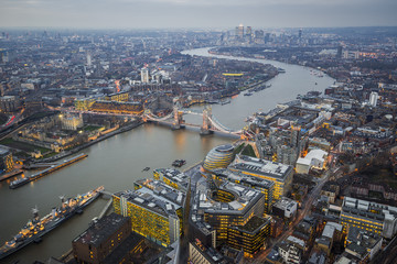 London, England - Aerial Skyline view of London with the amazing Tower Bridge, the Tower of London and skyscrapers of Canary Wharf at dusk