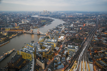 Fototapeta na wymiar London, England - Aerial Skyline view of London with the amazing Tower Bridge, the Tower of London and skyscrapers of Canary Wharf at dusk