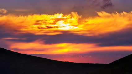 Picturesque sunrise, morning dawn in Carpathians, mountains silhouette Ukraine.