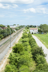 View of railroad track from steel net of a bridge