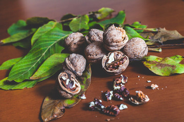 Fototapeta na wymiar Several walnut kernels and lie on brown background