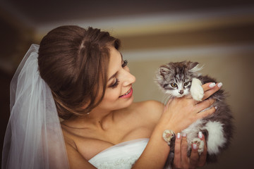 Bride holds cute little kitten