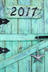 Year 2017 and tin star on old weathered door