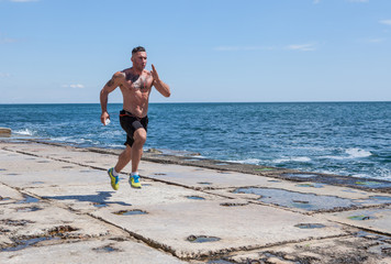 Fototapeta na wymiar Running man jogging on beach