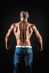 Obraz na płótnie Canvas very muscular handsome athletic man on black background