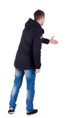 man in jacket holds out his hand for handshake. Isolated over white background.