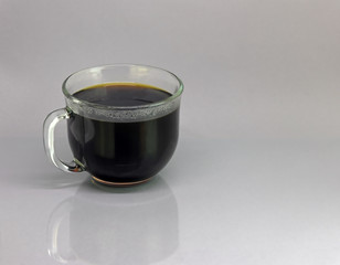 Cup of fresh hot coffee against a neutral background.